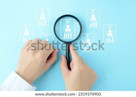 Human's hands using magnifying glass and business man's pictograms with bar graph