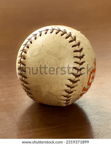 Used baseball ball with red stiching