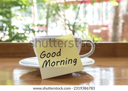 Paper note word Good morning the hot coffee cup.