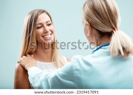 Caring blonde doctor and her patient. She understands her patient's needs, both physical and emotional, forging a bond of trust Royalty-Free Stock Photo #2319417091