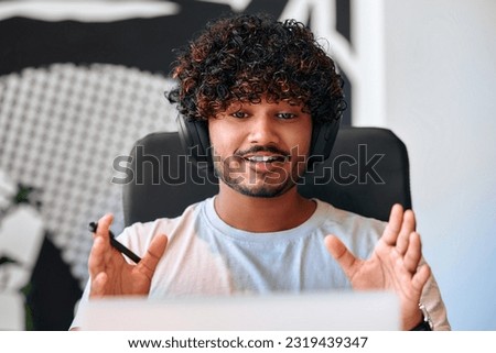 Call center employee accompanied by his team. Male businessman freelancer work in coworking, modern office. Young employee working with headset and laptop.