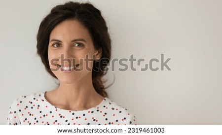Head shot portrait of positive woman with healthy toothy smile and perfect smooth skin on grey studio background isolated, happy attractive young female looking at camera, natural beauty concept