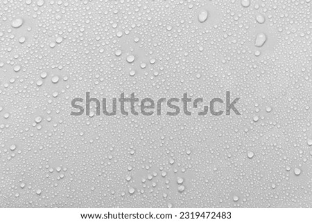 Water droplets on a gray background. Royalty-Free Stock Photo #2319472483
