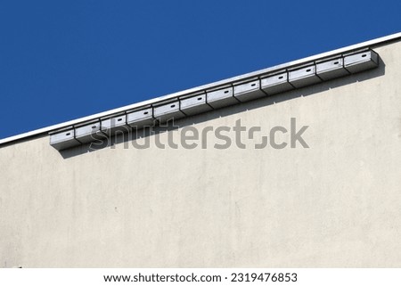 Nest boxes for  Swifts ( Apus apus ) hung on the wall of an apartment building, tongues fight mosquitoes and other insects, ecological and natural methods of combating nuisance insects in the city Royalty-Free Stock Photo #2319476853