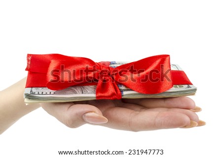 Money tied with red ribbon on a palm