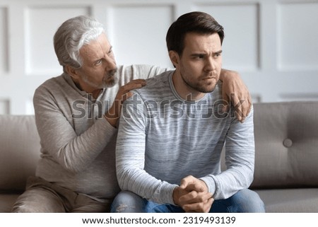 Loving elderly 70s Caucasian father hug comfort upset distressed grownup son feeling depressed or broken. Caring mature dad caress embrace show support and empathy to unhappy adult man kid. Royalty-Free Stock Photo #2319493139