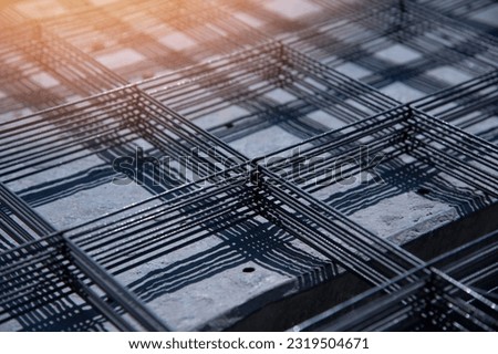 Wire mesh piles for construction. BRC welded steel wire mesh for concrete slab reinforcement of construction construction siteselective focus. Metal mesh folded into a flat stack Royalty-Free Stock Photo #2319504671