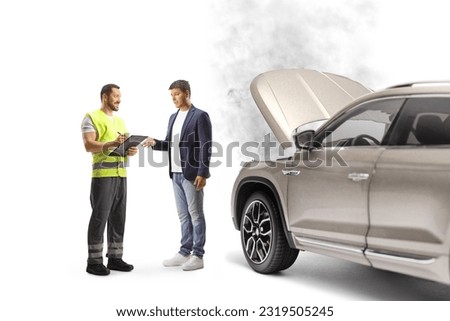 Road assistance worker and a man discussing a car problem  isolated on white background Royalty-Free Stock Photo #2319505245