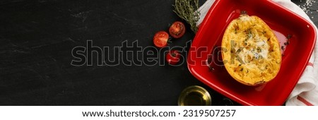 Half of cooked spaghetti squash with cheese in baking dish on black table, flat lay. Banner design with space for text Royalty-Free Stock Photo #2319507257