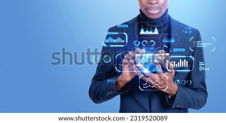 African businessman finger touch tablet, double exposure with business analytics dashboard with graph hud, metrics and KPI. Concept of marketing research and risk management Royalty-Free Stock Photo #2319520089
