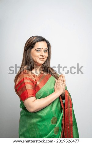 Indian woman doing namaste or welcome gesture. indian culture concept.