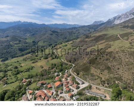 Aerial views of green Liebana valley, houses and mountains,  comarca of Cantabria, Spain.