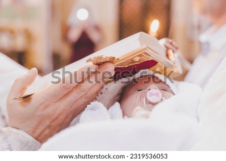 The sacrament of the baptism of a child. Selective focus. People.