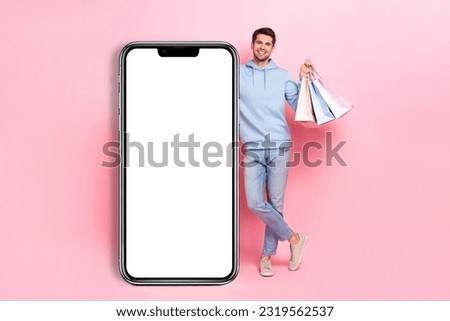 Full length size photo young student shopaholic guy stay big smartphone empty space screen amazon bargains promo isolated on pink color background