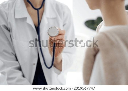 Doctor and a kid patient. Physician is holding stethoscope and ready to examine boy. Perfect health concept in medicine