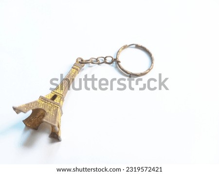 Keychain in the shape of the Eiffel Tower. The Eiffel Tower is one of the world's famous towers located in Paris, France.