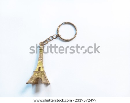Keychain in the shape of the Eiffel Tower. The Eiffel Tower is one of the world's famous towers located in Paris, France.