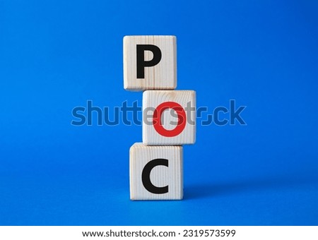 POC - Proof of Concept symbol. Wooden cubes with words POC. Beautiful blue background. Business and POC concept. Copy space.