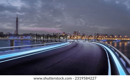 Cairo street at night in Egypt - road in Cairo city with buildings and Cairo tower in Background -	
