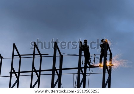 Welding work on tall buildings during evening hours. Good protection is required.