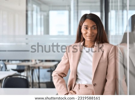 Smiling elegant confident young professional business woman, female proud leader, smart businesswoman lawyer or company manager executive looking at camera standing in office, portrait. Royalty-Free Stock Photo #2319588161