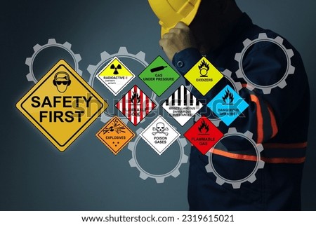Safety first sign with hazardous substance and yellow helmet staff background