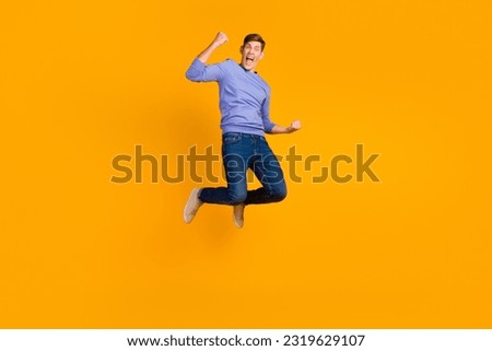 Full length photo of attractive crazy guy jump high supporting goal wear shirt jeans shoes isolated bright color background. Royalty-Free Stock Photo #2319629107