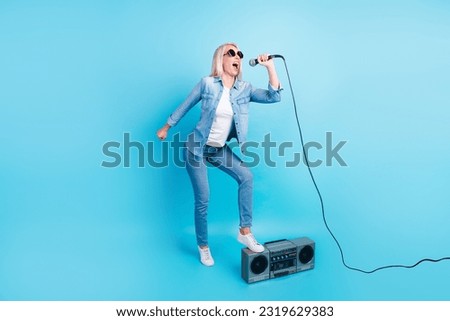 Full body photo shot cool woman stand one leg on retro boom bos recorder sing mic song.