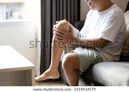 Asian middle aged man suffer from Arthritis,Patellar Tendinitis,symptom of Gout,deposition of chalkstones,painful inflammation and stiffness of the joints,ligament injuries,feel tingling pain in knee Royalty-Free Stock Photo #2319634579