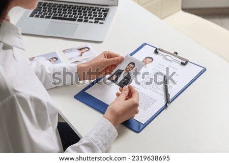 Human resources manager choosing employee at table, closeup