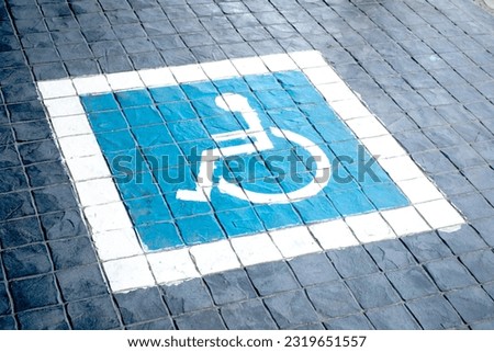 High angle view of a handicap icon at a parking spot in railway station outdoors.