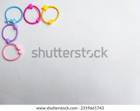 A frame of colorful elastic hair bands on white background. Space for text