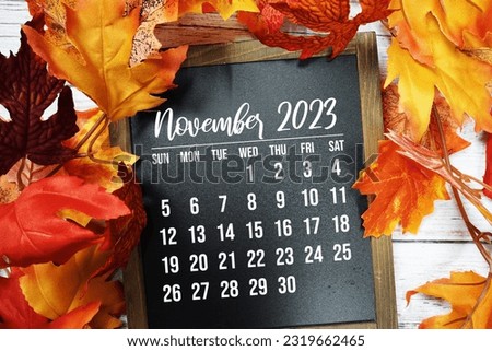 November 2023 monthly calendar with maple leaf on wooden background Royalty-Free Stock Photo #2319662465