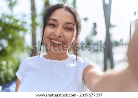 Young arab woman smiling confident making selfie by camera at street