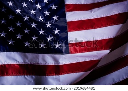 A closeup shot of the waving flag of the United States of America with interesting textures