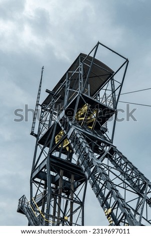 Shaft in the carnall zone. A steel structure adapted for an observation tower. Yellow hoist wheel. Zabrze , Poland
