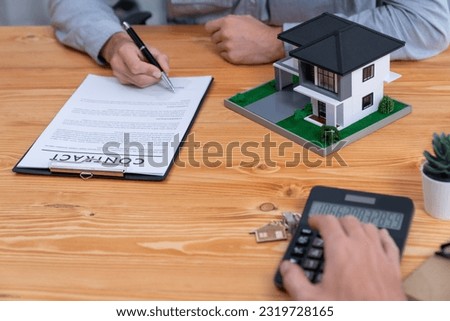 New home owner signing house loan or rental lease contract after agreeing to term and condition with real estate agent. Contract document with client's signature as housing business concept. Entity