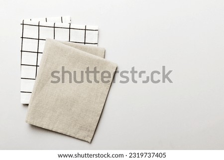 top view with gray kitchen napkin isolated on table background. Folded cloth for mockup with copy space, Flat lay. Minimal style. Royalty-Free Stock Photo #2319737405
