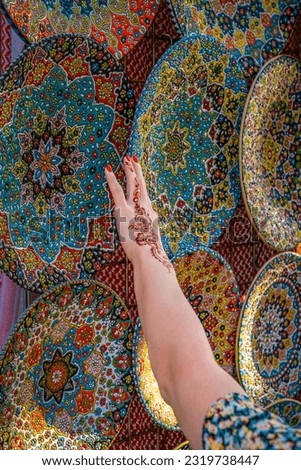 A young woman with henna on her hands at the Dubai market.