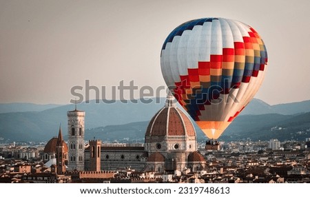 Hot air balloon rising in front of the Duomo in Florence during sunrise from Piazzale Michelangelo, Florence, Italy. Europe Travel Concept. Cityscape. Royalty-Free Stock Photo #2319748613