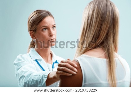 Patient and her doctor in a close bond. The blonde physician genuinely cares for her patient, addressing both physical and emotional needs Royalty-Free Stock Photo #2319753229