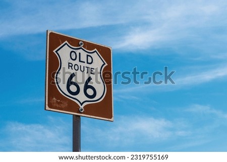 Historic Old Route 66 sign with blue sky in background