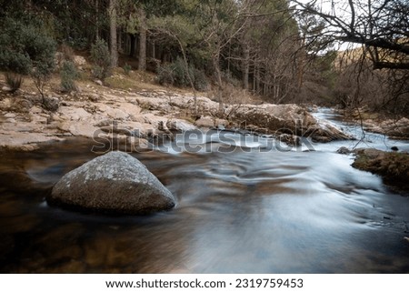 Breathtaking Landscape Photography: A panoramic image showing the majestic mountains of La Pedriza and its meandering river in the foreground.