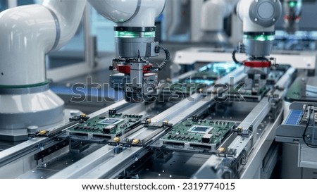 Component Installation and Quality Control of Circuit Board. Fully Automated PCB Assembly Line Equipped with High Precision Robot Arms at Electronics Factory. Electronic Devices Manufacturing Industry Royalty-Free Stock Photo #2319774015