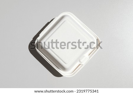 A closed white cardboard box for a bento cake to take away, highlighted on a white background. Disposable Food Packaging box, container Royalty-Free Stock Photo #2319775341
