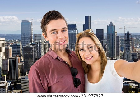 Young couple taking a selfie with the Seattle skyline in the background