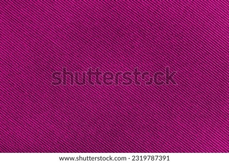 Pink, purple carbon fiber background. Texture of red fabric for tailoring. Textile
