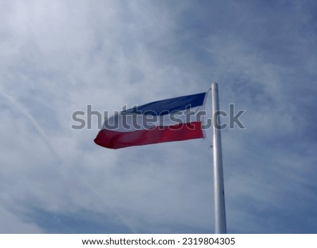 You see the flag of Schleswig-Holstein, North Germany, Europe