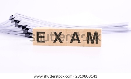 wooden cubes with text EXAM on white table