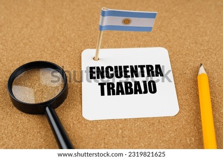 On the table is the flag of Argentina, a pencil, a magnifying glass and a sheet of paper with an inscription in Spanish which translates into English as - find job